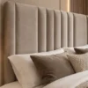Close-up of the Auro Sora upholstered headboard with vertical channel detailing.