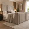 Auro Sora upholstered TV bed shown in a warm contemporary bedroom setting.