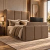 Auro Veyra wingback TV bed with the television raised from the upholstered footboard.